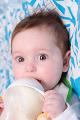 Image showing Six-month girl drinks milk from a bottle