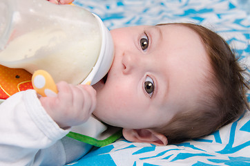 Image showing Baby drinking milk from a bottle