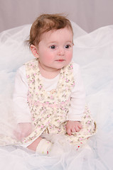 Image showing Six-month girl sitting in tulle