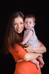 Image showing Happy mother holding a baby