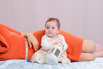 Image showing Girl with a nightlight is sitting next to her mother