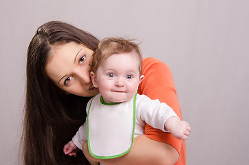 Image showing Young happy mother kissing her daughter