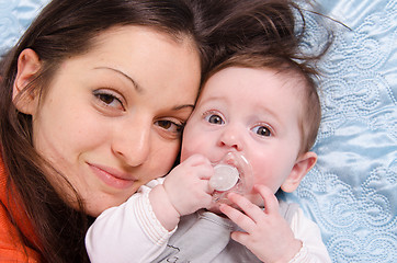 Image showing Portrait of mother and baby lying in a crib