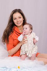 Image showing Mom and daughter on the bed six-month