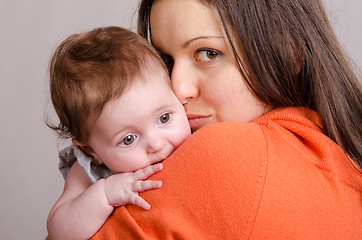 Image showing Sad girl on hands happy mom