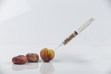 Image showing Peaches and syringe with pills