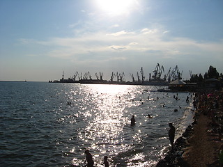 Image showing evening sea with hoisting crane in the seaport