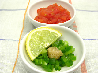 Image showing Little bowls of chinaware with tomatodip and green pepperdip