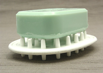 Image showing Green soap on a soap dish on a gray  background