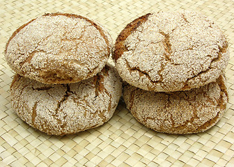 Image showing Home made wholemeal vinschgauer buns on rattan underlay