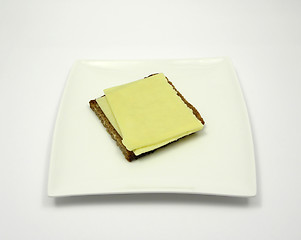 Image showing Wholemeal bread with two slices of cheese on a plate