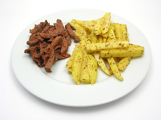 Image showing Soy Geschnetzeltes and french fries on white plate