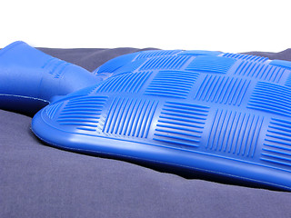 Image showing Blue hot-water bag on a blue pillow