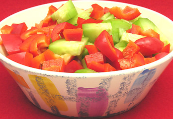 Image showing Slices of cucumber and red pepper in a ceramics bowl 