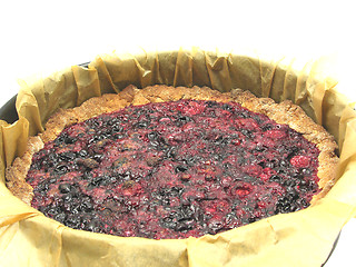 Image showing Delicious berry cake in baking pan with baking paper