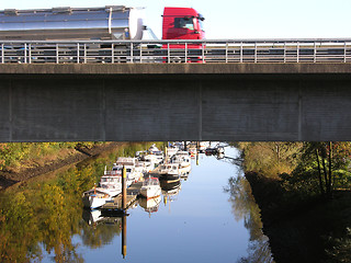 Image showing Truck on a road above a boat canal in Oldenburg 