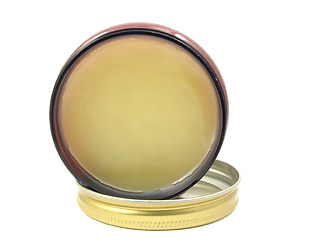 Image showing Yellow hair wax in a little open glass with lid