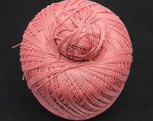 Image showing Pink balls of wool  on a black background