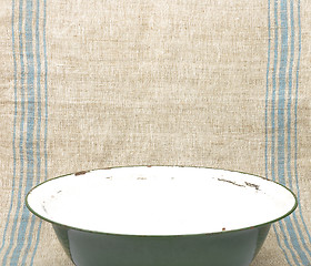 Image showing Bowl of enamel on linen sheet
