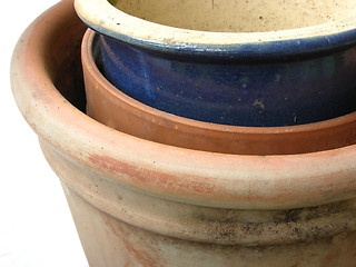 Image showing Three stacked brown and blue plant pots