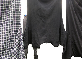 Image showing Clothesline  with some laundered clothes on white