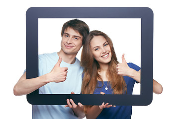Image showing Happy couple looking through tablet frame