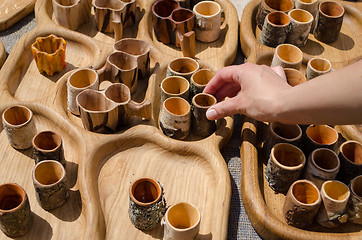 Image showing hand take wooden hand carved stemware sold in fair 