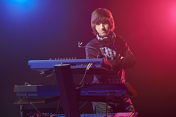 Image showing Musician sitting on a keyboard