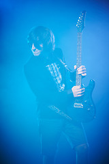 Image showing Young guitarist performing on stage