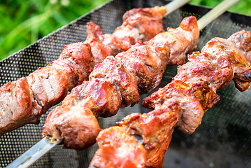 Image showing Hot shish kebab on metal skewers