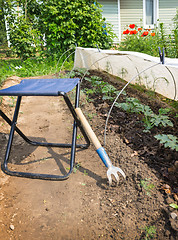 Image showing Folding chair and rake