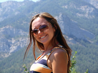 Image showing Portrait of the young beautiful girl on a background of mountain