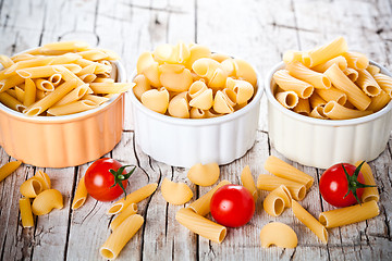 Image showing three bowls with uncooked pasta and cherry tomatoes