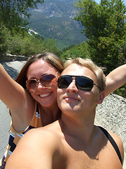 Image showing Portrait of young pair in sunglasses on mountain road