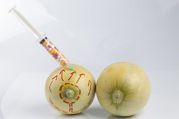 Image showing Melons and syringe with pills