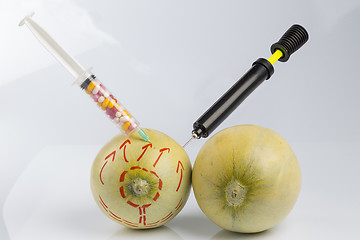 Image showing Melons, syringe with pills and bicycle pump