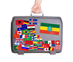 Image showing Used plastic suitcase with stickers