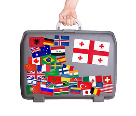 Image showing Used plastic suitcase with stickers