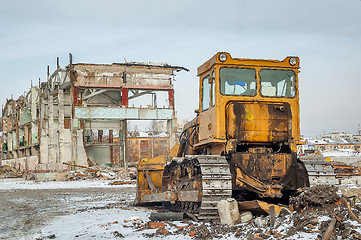 Image showing Bulldozer in front of old industrial building