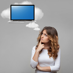 Image showing Thinking woman and laptop on cloud