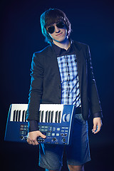 Image showing Musician holding a keyboard
