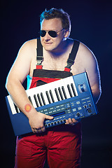 Image showing Musician holding a keyboard