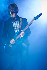Image showing Young guitarist performing on stage