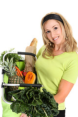 Image showing Woman displaying bag full of groceries