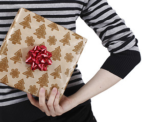 Image showing Young woman holding a present