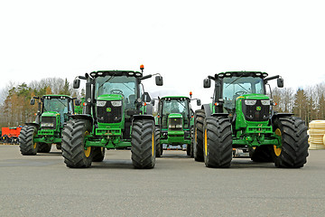 Image showing Four John Deere Agricultural Tractors on a Yard