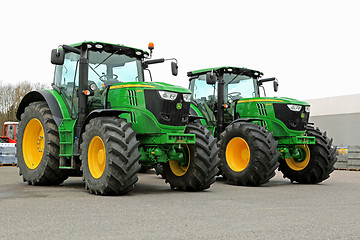 Image showing Two John Deere 6210R Agricultural Tractors on a Yard.