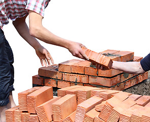 Image showing Workers laid red bricks