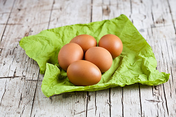 Image showing  fresh brown eggs on green napkin 