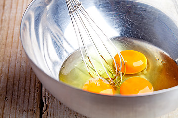 Image showing whisking eggs in metal bowl 